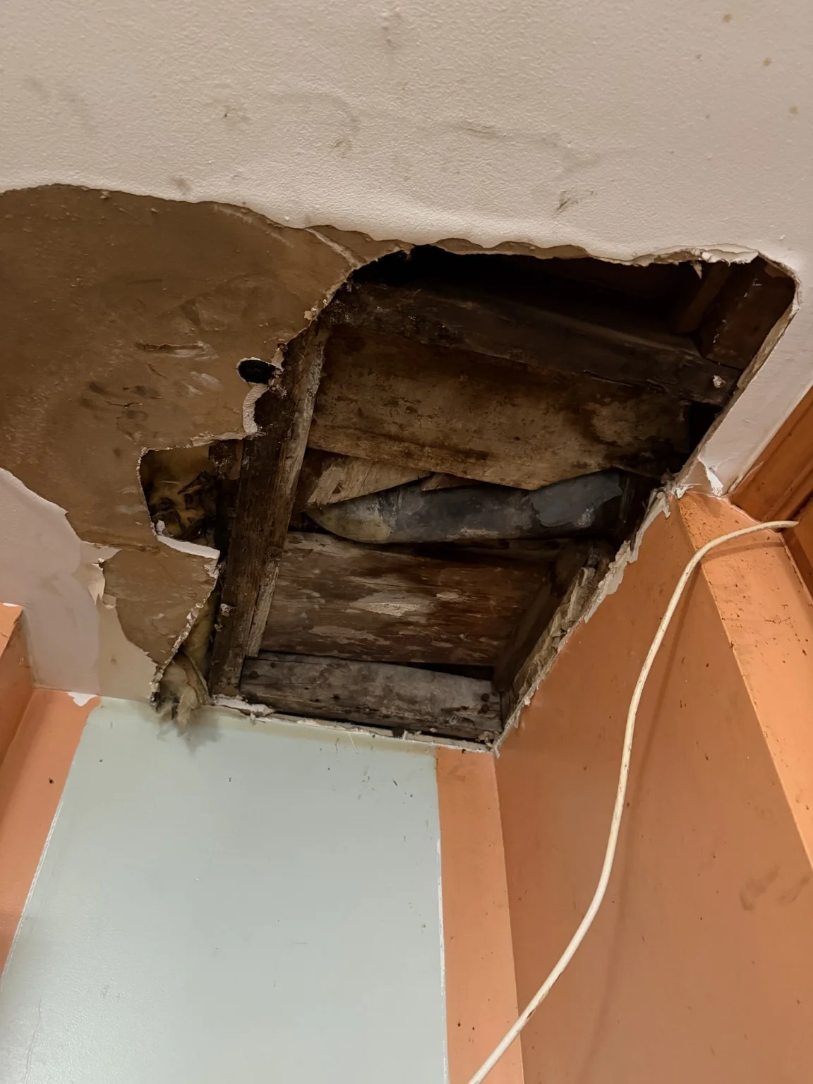 Ceiling opened to locate plumbing leak and water damage