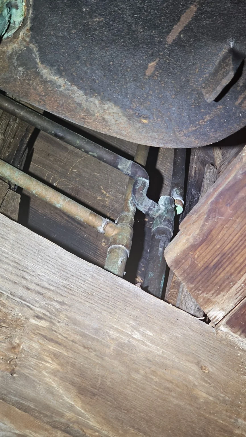 Exposed copper plumbing lines inspected for an emergency pipe leak