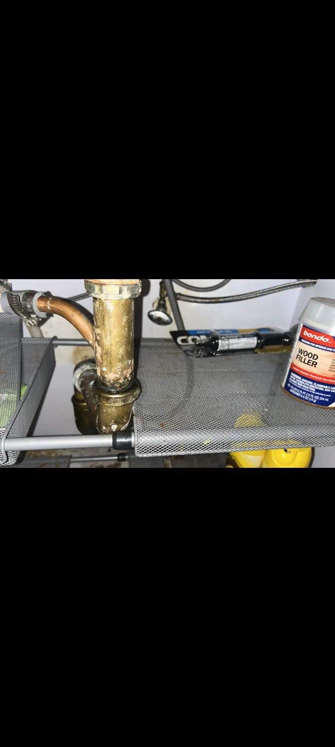 Corroded sink drain pipe requiring leak repair