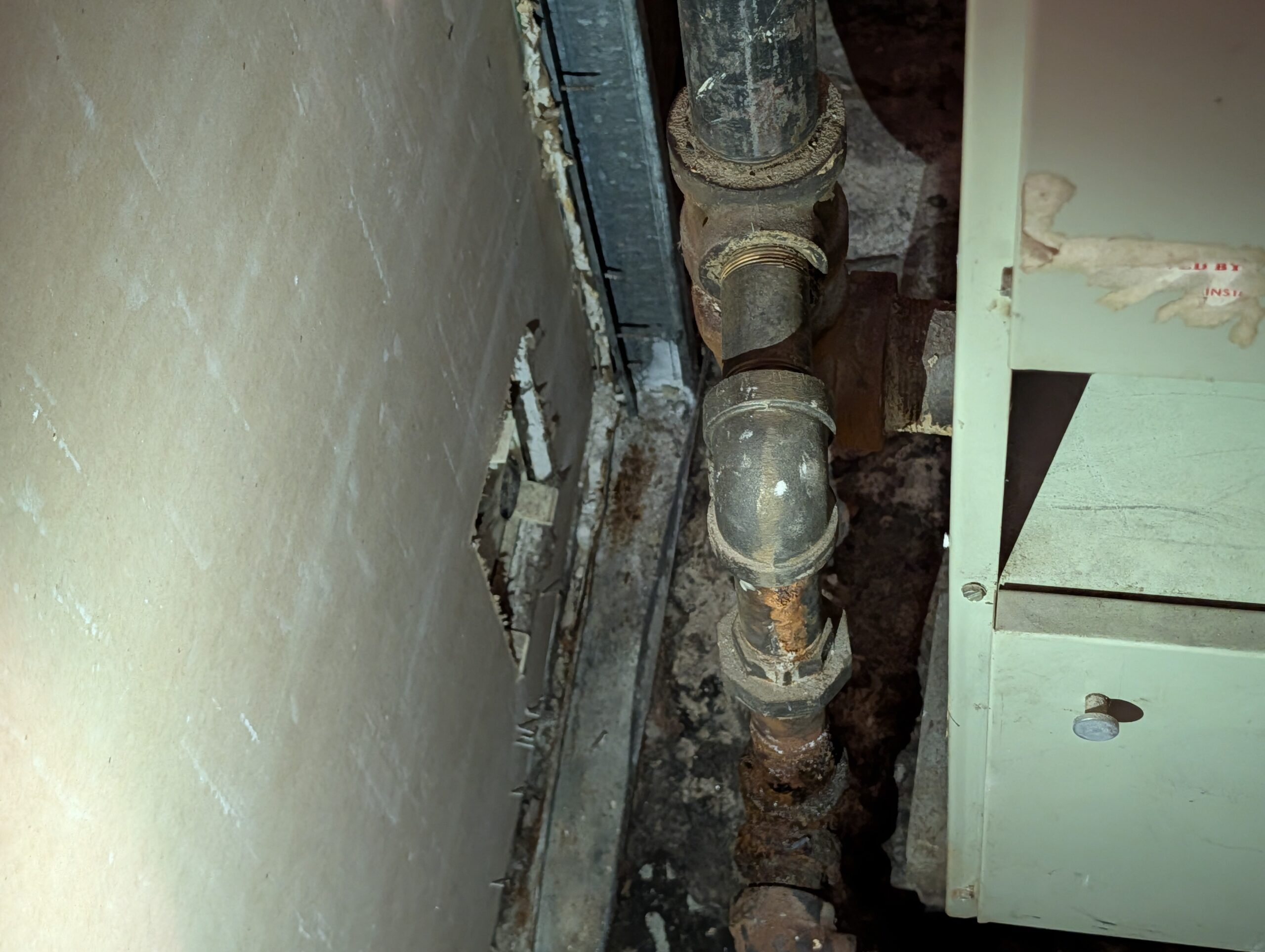 Severely corroded heating pipe fitting evaluated in basement